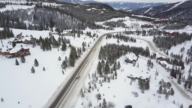 Snowy mountain road in Montana, wide aerial