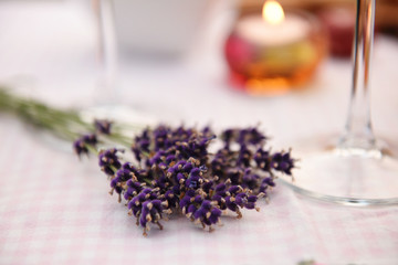 Obraz na płótnie Canvas Bunch of fresh lavender and a burning candle
