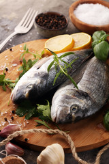 Delicious fresh fish. Fish with aromatic herbs, spices and vegetables - healthy food, diet or cooking concept.