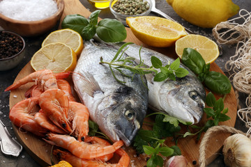 Delicious fresh fish. Fish with aromatic herbs, spices and vegetables - healthy food, diet or cooking concept.