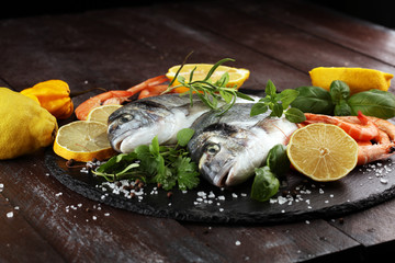 Delicious fresh fish. Fish with aromatic herbs, spices and vegetables - healthy food, diet or cooking concept.