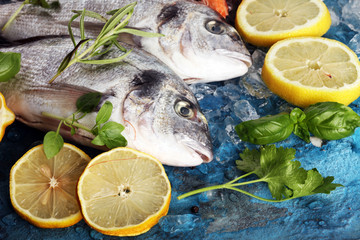Delicious fresh fish. Fish with aromatic herbs, spices and vegetables - healthy food, diet or cooking concept.