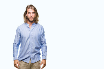 Fototapeta premium Young handsome man with long hair over isolated background with serious expression on face. Simple and natural looking at the camera.
