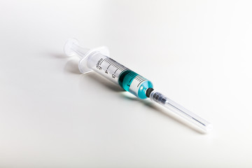 One syringe on white table prepared for injection in hospital