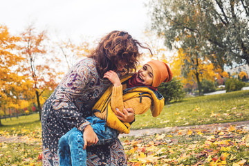Mother and little son playing and having fun together in a park