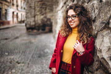 Cute girl with curly hair walking outdoor