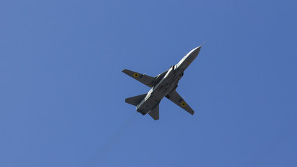 fighter flies against the blue sky, military aircraft