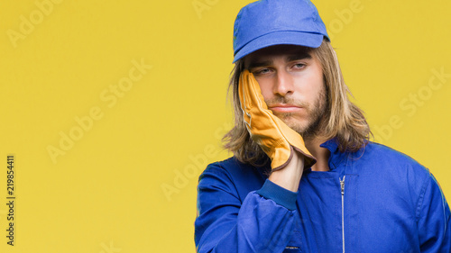Young Handsome Mechanic Man With Long Hair Over Isolated
