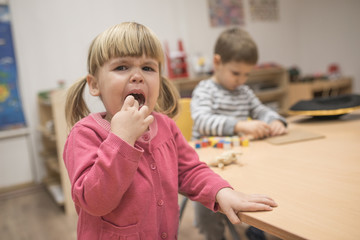 Portrait of crying little caucasian girl, looking at camera