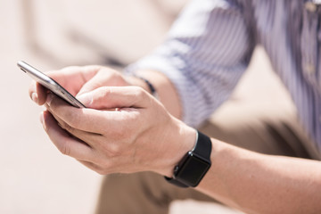Close up of a modern man using his smartphone