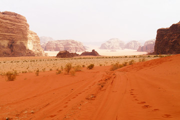 Wadi Rum desert, Jordan, Middle East, known as The Valley of the Moon.  Orange sand, blue sky, haze...