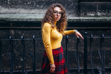 Cute girl with curly hair walking outdoor