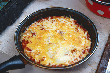 Fototapeta na wymiar Tomato sauce with cheese in a frying pan