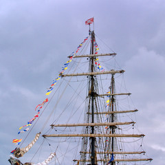 Image of the mast of a sailing ship with signal flags.