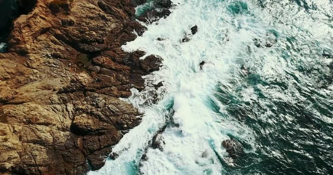 Waves Crash On Rocky Shore In California, Overhead Aerial