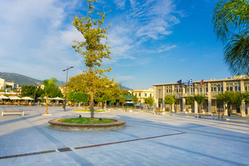 Vallianou square, the central square of Argostoli city in Kefalonia ionian island in Greece. The square is paved with many trees and palms. 