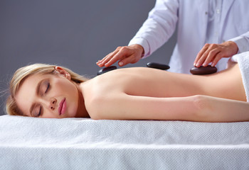 Young woman lying on a massage table,relaxing with eyes closed. Woman. Spa salon