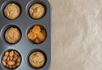 Healthy vegan oat muffins, almond and dried apricots top view