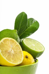 Fresh Limes and Lemons with Leaves in the Bowl
