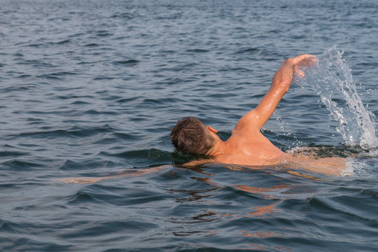 Young man swimming in the lake