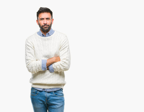 Adult hispanic man wearing winter sweater over isolated background skeptic and nervous, disapproving expression on face with crossed arms. Negative person.