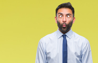 Adult hispanic business man over isolated background making fish face with lips, crazy and comical gesture. Funny expression.
