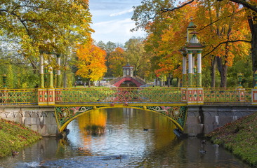 Fototapeta na wymiar Cross bridge in golden fall in Alexander park, Pushkin, Saint Petersburg, Russia