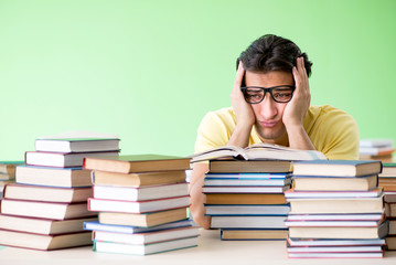 Student with too many books to read before exam