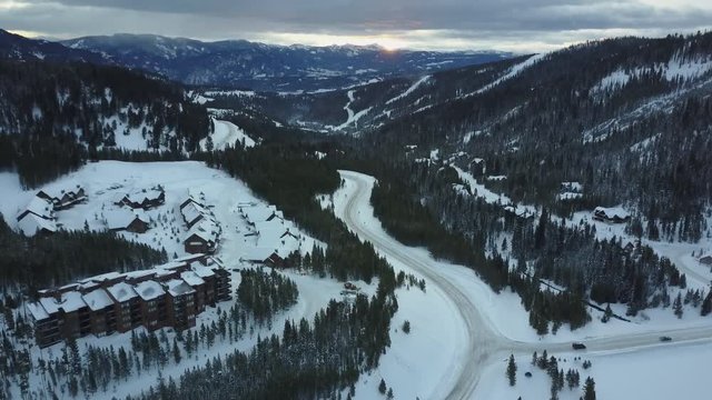 Tilt up aerial, rural road in Montana mountains