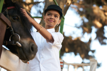 Portrait of young girl with horse. Young cute girl having fun with horse 