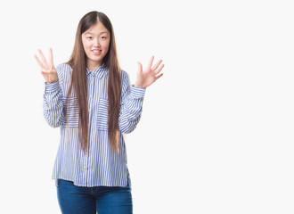 Young Chinese woman over isolated background showing and pointing up with fingers number eight while smiling confident and happy.