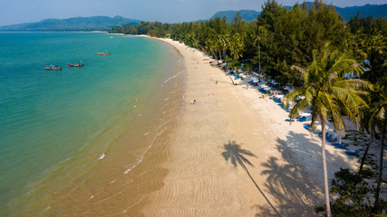 Aerial view of late afternoon shadows being cast onto a beautiful tropical sandy beach in Thailand (Coconut Beach, Khao Lak)