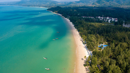 Aerial drone view of a beautiful empty sandy beach and tropical coastline