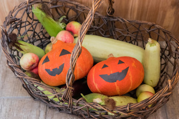 Pumpkins and fall harvest decorative vegetables in a wicker basket for Thanksgiving decoration