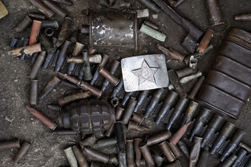 Military background with weapons trophies. The Second World War of Germany with the USSR and the countries of Europe. Coat of arms of the Soviet Union on a belt buckle.