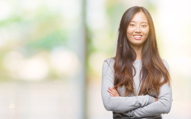 Fototapeta premium Young asian woman over isolated background happy face smiling with crossed arms looking at the camera. Positive person.