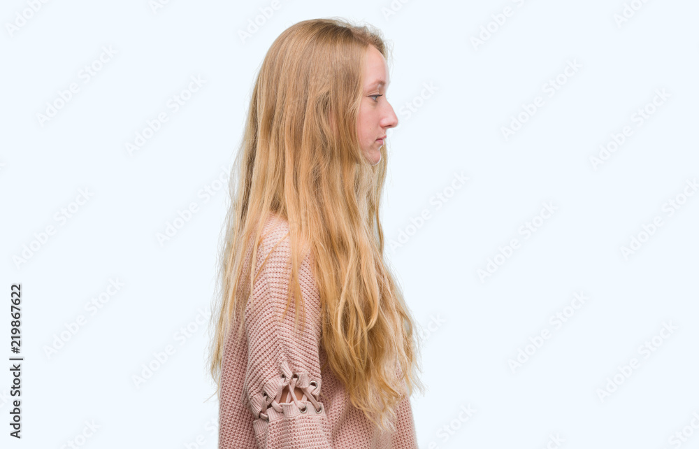 Sticker blonde teenager woman wearing pink sweater looking to side, relax profile pose with natural face wit