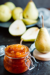 Homemade pear jam on dark background on background fresh ripe pears  