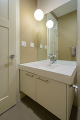 Modern bright bathroom with sink and large mirror. Interior design.