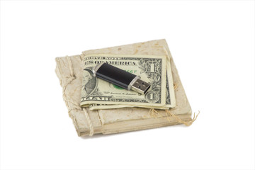 information storage systems: a small vintage notebook, a couple of dollars and a flash drive on it, isolated on white