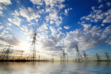 Many electric towers in the sunset sky background