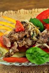 Roast meat with vegetables and basil  leaves, close-up, vertical frame.