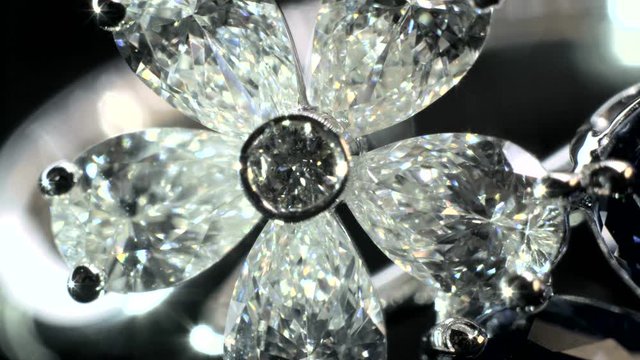 Close-up shot of two sparkling,shining white and blue flower shaped ring with diamonds and saphire jewelery.