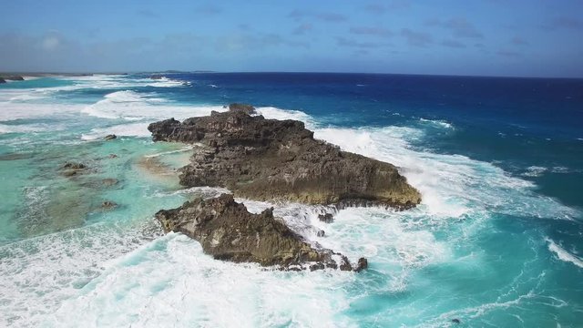 Waves crash on Turks and Caicos coast, panning aerial