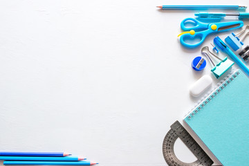 blue school supplies with place for text on a white background