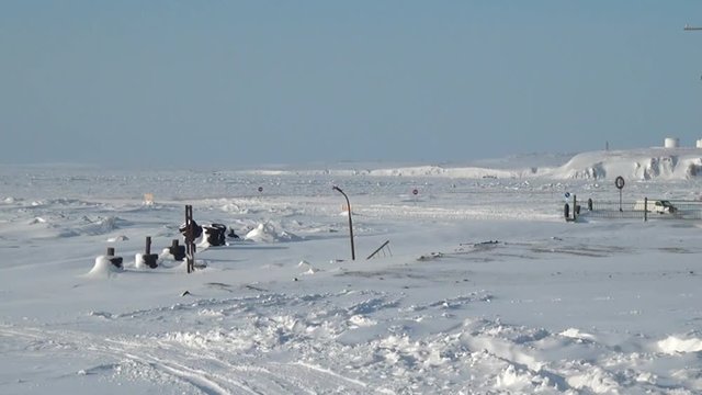 Snowdrift on Way to the Anadyr airport and an abandoned village. Road through township Coal Mines to ghost town Gudym Chukotka. Former secret military base in far north of Russia.