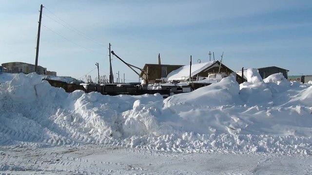 Snowdrift on Way to the Anadyr airport and an abandoned village. Road through township Coal Mines to ghost town Gudym Chukotka. Former secret military base in far north of Russia.