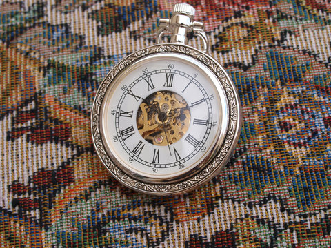 vintage classic pocket watch over vintage fabric