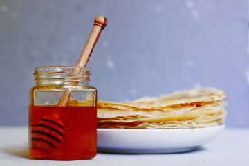 bottle of honey with stick