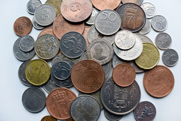 Modern and out of use coins of European countries. Selective or blurred focus with bright light.